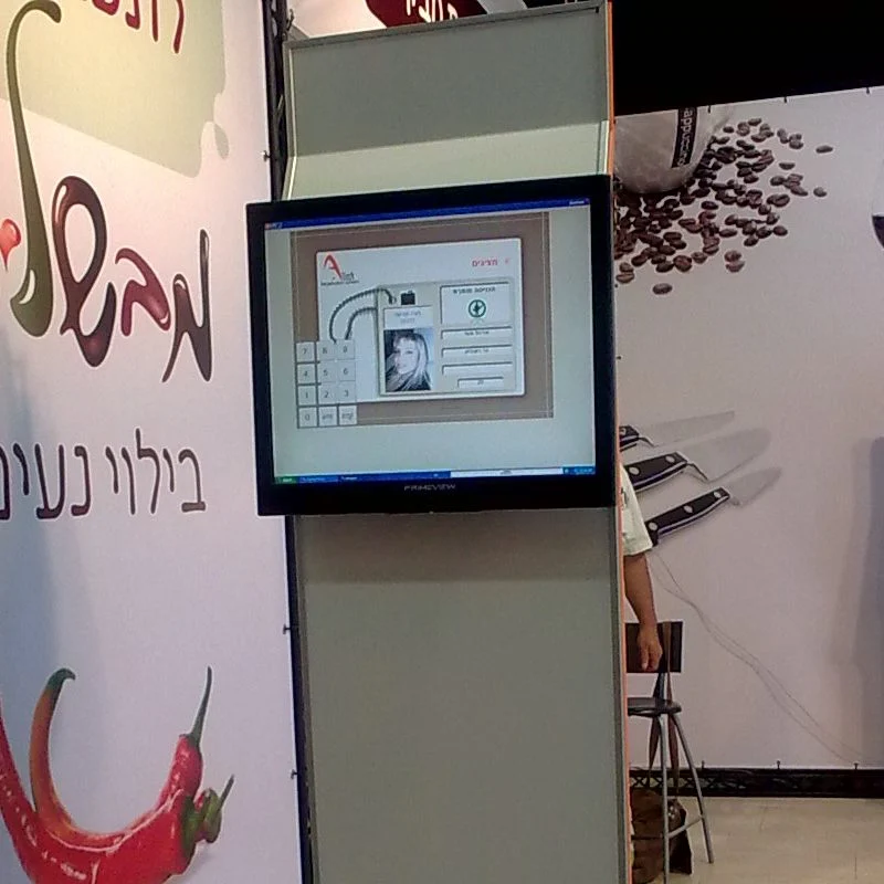 An ALIST gate station at the entrance to an exhibition hall: the registrant's photograph on screen beside the approval buttons
